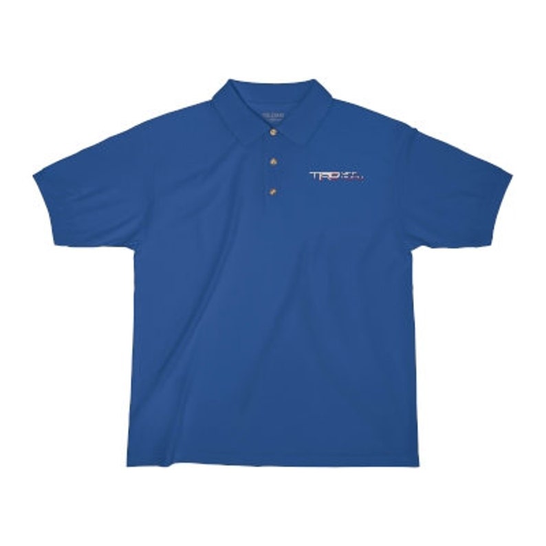 May include: A royal blue polo shirt with a small embroidered logo on the left chest. The logo is in white and pink and says "TRPX".