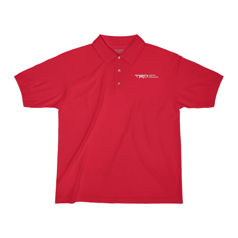 May include: Red short-sleeved polo shirt with a white embroidered logo that says "TRD OFF ROAD"