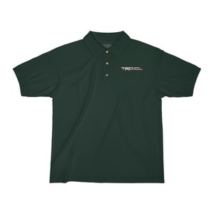 May include: A dark green polo shirt with a white embroidered logo that says "TRD OFF ROAD" on the left chest.