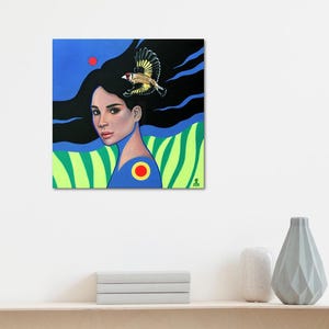 May include: A square painting featuring a portrait of a person with long black hair flowing into a dark background. A small bird with yellow and black wings is perched above the head. The lower section displays green vertical stripes and a blue shirt.