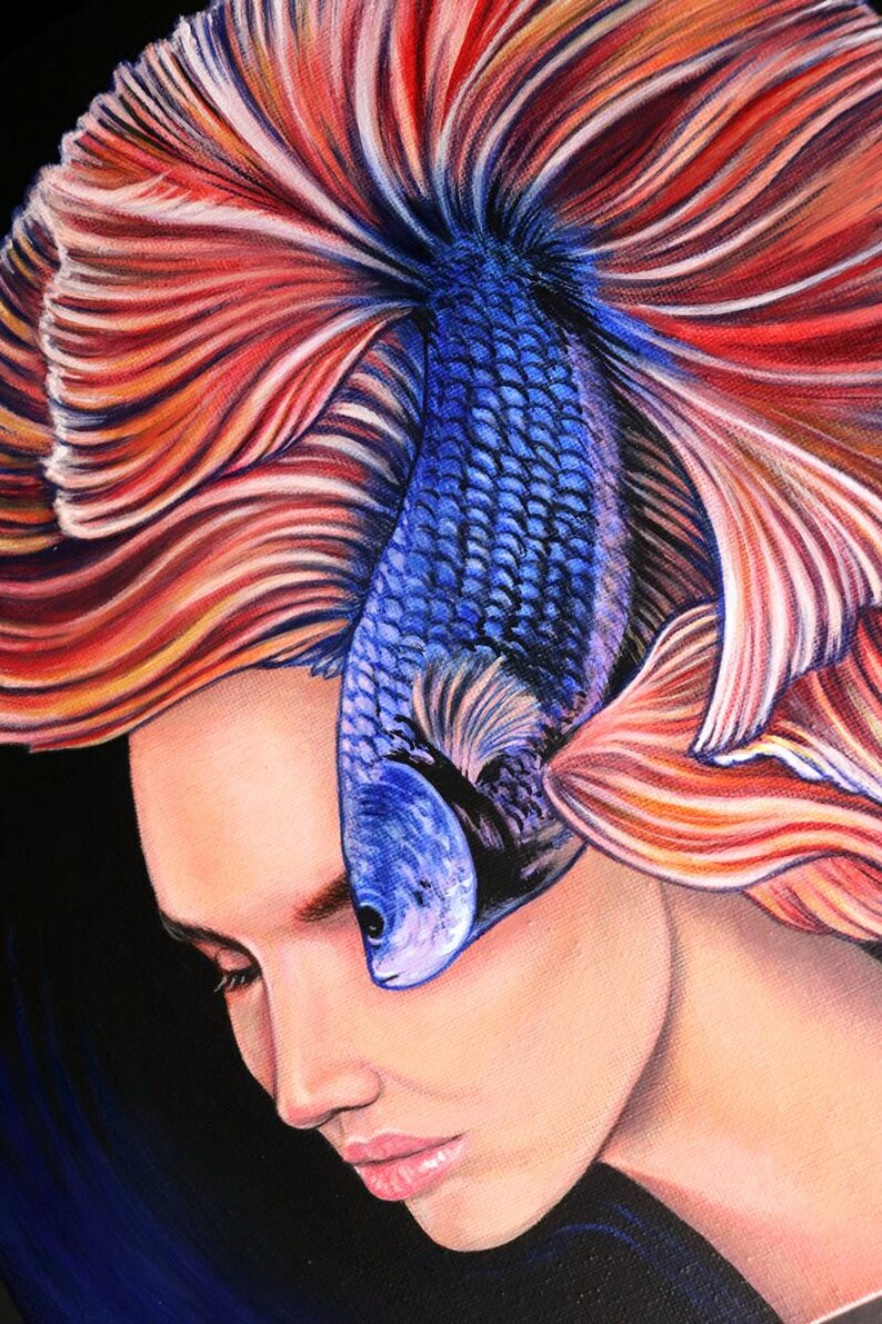 May include: A detailed painting depicting a person with closed eyes, whose hair is replaced by the flowing, vibrant red and orange fins of a blue betta fish. The fish's body rests vertically against the forehead, featuring textured blue scales.