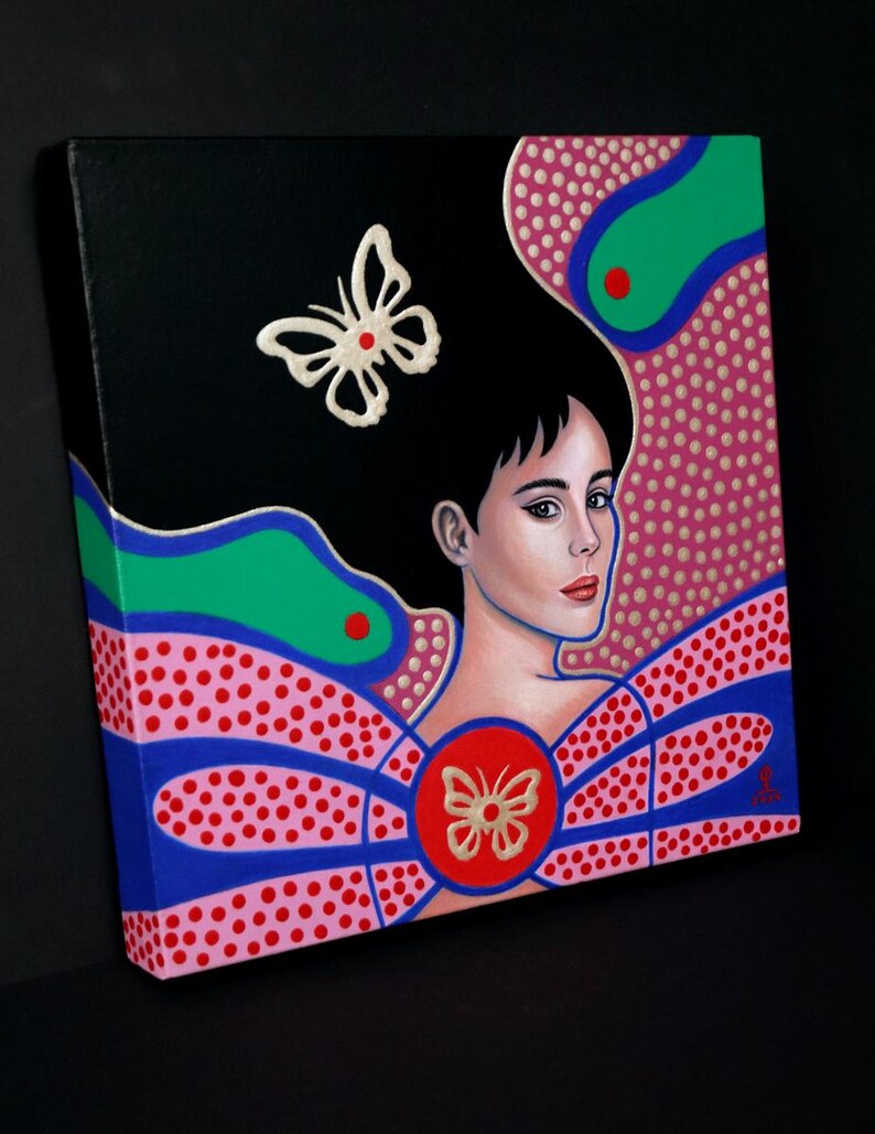 May include: A square canvas painting featuring a portrait of a person with dark hair against a black background. The composition includes vibrant green, blue, and pink dotted patterns, with two white butterfly motifs and a central red circle.