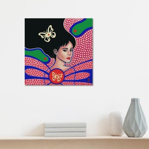 May include: A square art print featuring a portrait of a person with dark hair, accented by two cream-colored butterfly illustrations. The background displays a vibrant pattern of red dots on a pink field, with blue and green curved shapes.