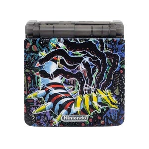 May include: A black Nintendo Game Boy Advance SP with a colourful, abstract design featuring a creature with yellow, red, and blue stripes. The design includes the text "Nintendo" in white.