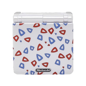 May include: A white Game Boy Advance SP with a red and blue geometric pattern. The Nintendo logo is visible on the bottom of the device.