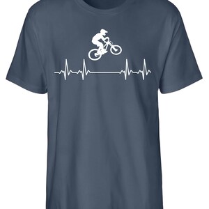 May include: A dark blue t-shirt featuring a white silhouette of a person riding a mountain bike with a heartbeat graphic below.