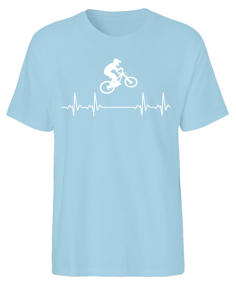 May include: A light blue t-shirt featuring a white silhouette of a person riding a mountain bike over a white heartbeat graphic.