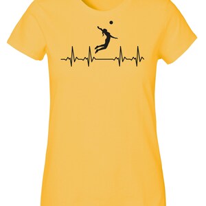 May include: Yellow t-shirt with a black silhouette of a volleyball player spiking a ball, with a black heartbeat line below.