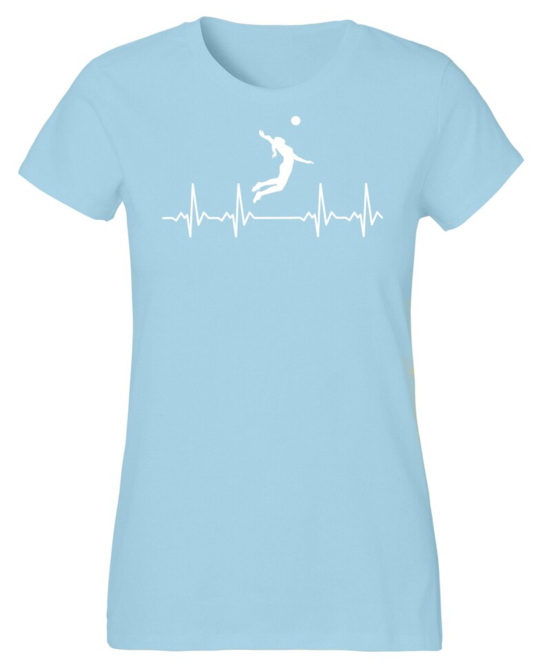 May include: Light blue t-shirt with a white silhouette of a volleyball player spiking a ball, with a white heartbeat line below.