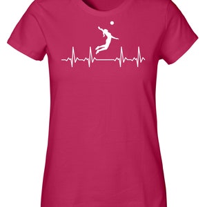 May include: A pink women's t-shirt with a white silhouette of a volleyball player spiking the ball, with a white heartbeat line below.