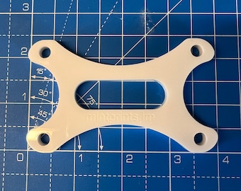 May include: White plastic 3D printed part with a rectangular opening and four holes. The part is marked with "mintprints, Im" and angle measurements in degrees.