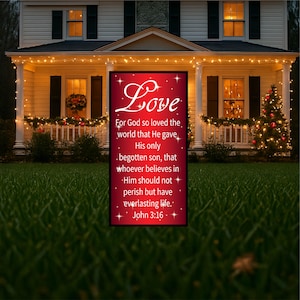 May include: A red and white Christmas sign with the word "Love" in a decorative font. The sign features a Bible verse from John 3:16, "For God so loved the world that He gave His only begotten son, that whoever believes in Him should not perish but have everlasting life."