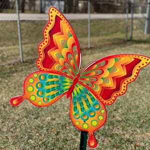 Orange and yellow butterfly garden stake:  whimsical orange butterfly lawn signs with playful patterns and vivid hues