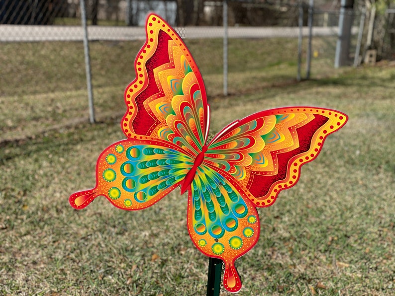 Orange and yellow butterfly garden stake:  whimsical orange butterfly lawn signs with playful patterns and vivid hues