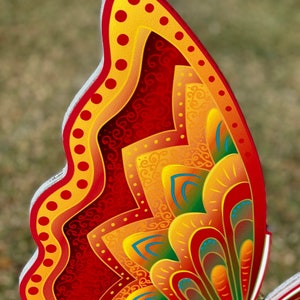 edge view of Orange and yellow butterfly garden stake:  Orange and yellow butterfly garden stake:  whimsical orange butterfly lawn signs with playful patterns and vivid hues