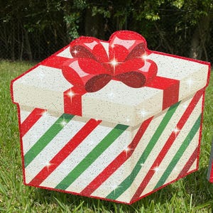 A Christmas Present Yard Decoration-bright and colorful gift box 3D design in green, red white with Christmas green and red stripes and a red bow