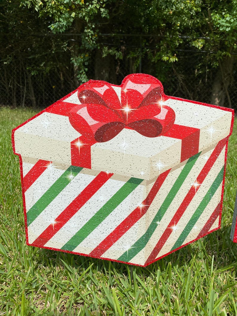 A Christmas Present Yard Decoration-bright and colorful gift box 3D design in green, red white with Christmas green and red stripes and a red bow