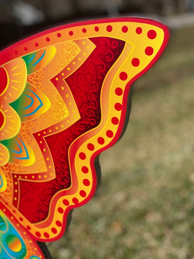outline of Orange and yellow butterfly garden stake: Orange and yellow butterfly garden stake:  whimsical orange butterfly lawn signs with playful patterns and vivid hues