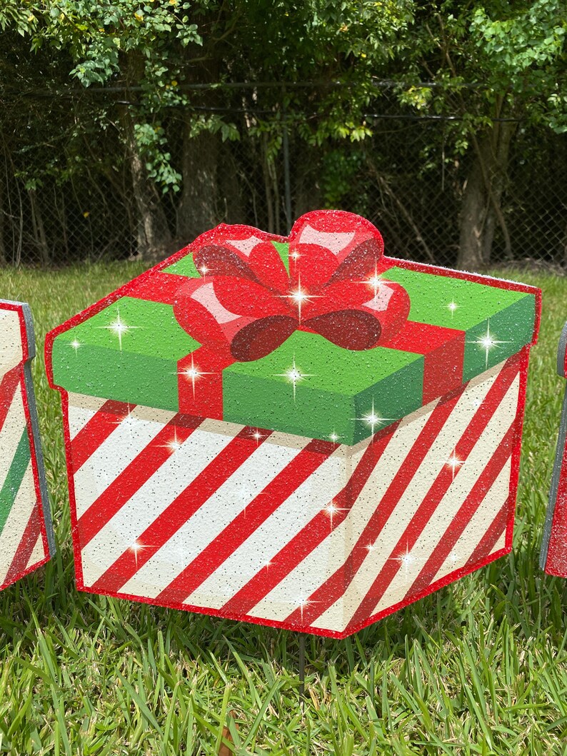 A Christmas Present Yard Decoration-bright and colorful gift box 3D design in green, red white with Christmas red and white stripes and a red bow