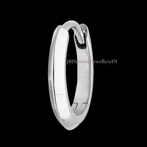 May include: A single, polished silver hoop earring against a black backdrop. The earring features a smooth, rounded design with a secure clasp. The text "JBDiamondJewelleryIN" is visible on the earring.