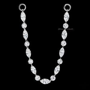 May include: A silver-toned jewellery connector chain featuring alternating marquise-cut and round-cut clear stones. The chain is arranged in a U-shape with a circular jump ring at each end. The text JBDiamondJewelleryIN is visible on the right side.