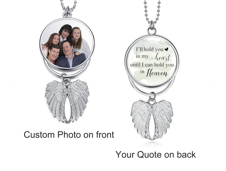 May include: Silver necklace with a round pendant featuring a photo on the front and a quote on the back. The quote reads "I'll hold you in my heart until I can hold you in Heaven". The pendant is attached to a silver chain and has angel wings hanging below.