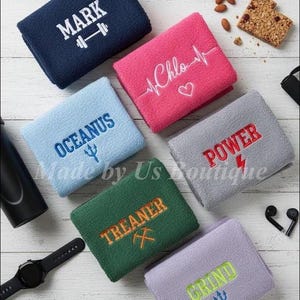 May include: A set of three ceramic mugs with a speckled, matte finish. The mugs are in shades of cream, light brown, and dark brown. Each mug has a simple, minimalist design and a rounded handle.