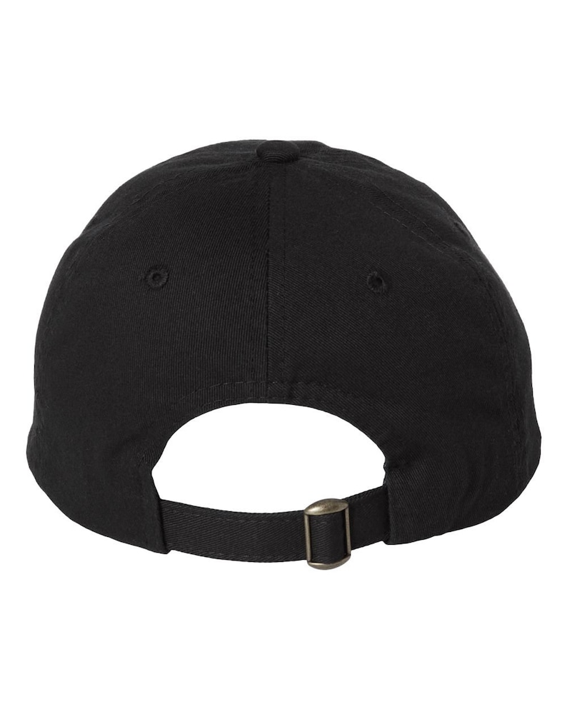 The back side of a baseball hat showing and adjustable strap and buckle.