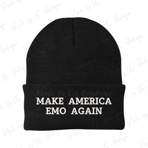 May include: Black beanie with white text that reads "Make America Emo Again".