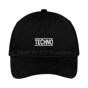 May include: A black baseball cap with a white embroidered "TECHNO" text on the front.