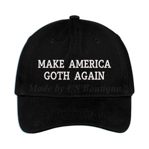 May include: Black baseball cap with white embroidered text that reads "Make America Goth Again".