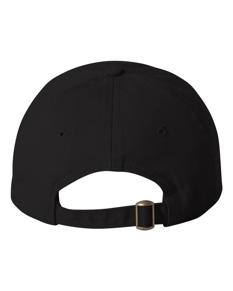 The back side of a baseball hat showing and adjustable strap and buckle.