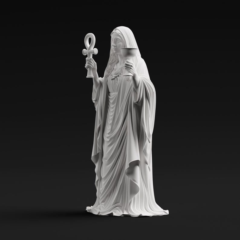 May include: A matte white statue of a robed figure with a hooded head, holding an ankh symbol in the right hand and a chalice in the left hand. The figure wears a long, flowing garment with detailed vertical folds and drapes throughout the fabric.
