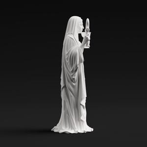 May include: A white matte statue of a figure draped in long, flowing robes and a head covering. The figure is shown in profile, holding a tall, slender chalice-like object with both hands near the face, featuring detailed folds in the fabric.