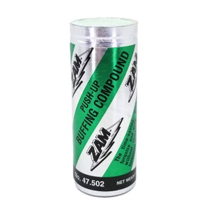 May include: A cylindrical metal container of "ZAM Push-Up Buffing Compound." The label features a silver and green striped design with the product name in bold, black letters. The bottom of the container has the number "47.502."