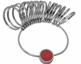 May include: A silver ring sizer with a red center piece. The sizer has a series of rings numbered 16 through 23.