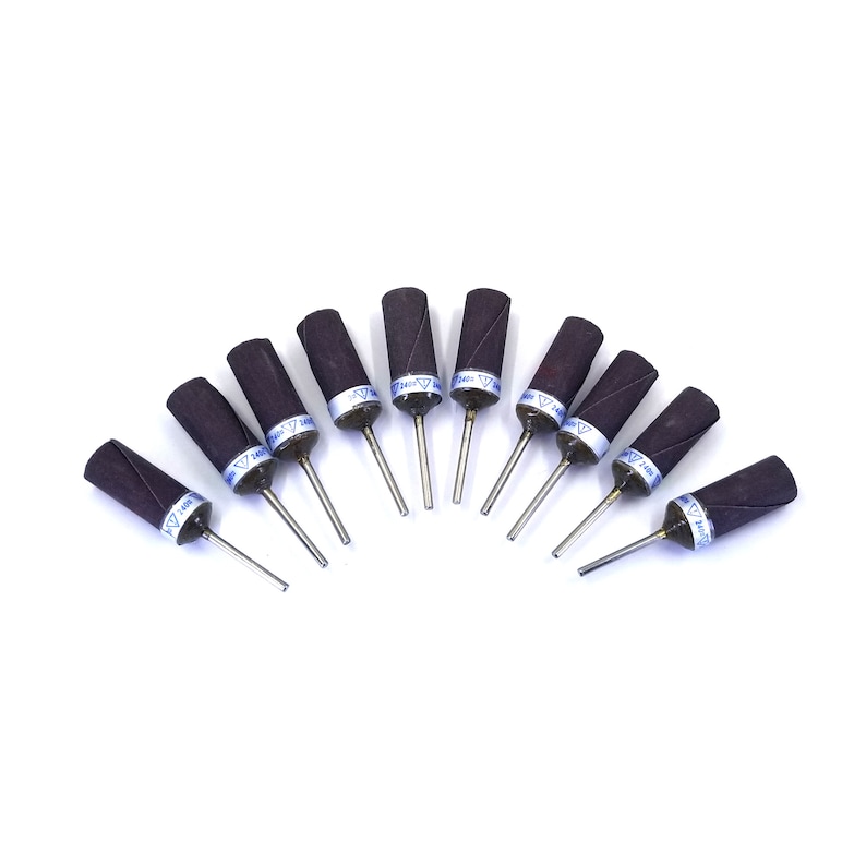 May include: Ten brown sanding drums with a metal shaft. Each drum has a blue label with the text "140 Grit" printed on it.