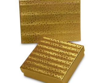 May include: Two gold-colored gift boxes, one open and one closed, are displayed against a white background. The boxes have a textured, crackled pattern. The open box is in the foreground, and the closed box is behind it.