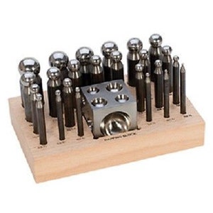 May include: A set of 40 metal punches and a metal block with different sized round depressions, all organized in a wooden tray. The tray has labels for each punch size.