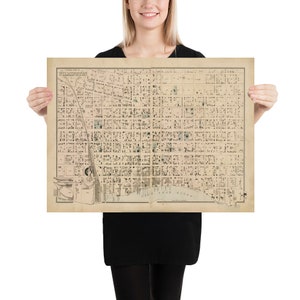 May include: A vintage map of Wilmington, Delaware, printed on aged paper with a grid pattern and text labels. The map shows the city's streets, waterways, and landmarks.