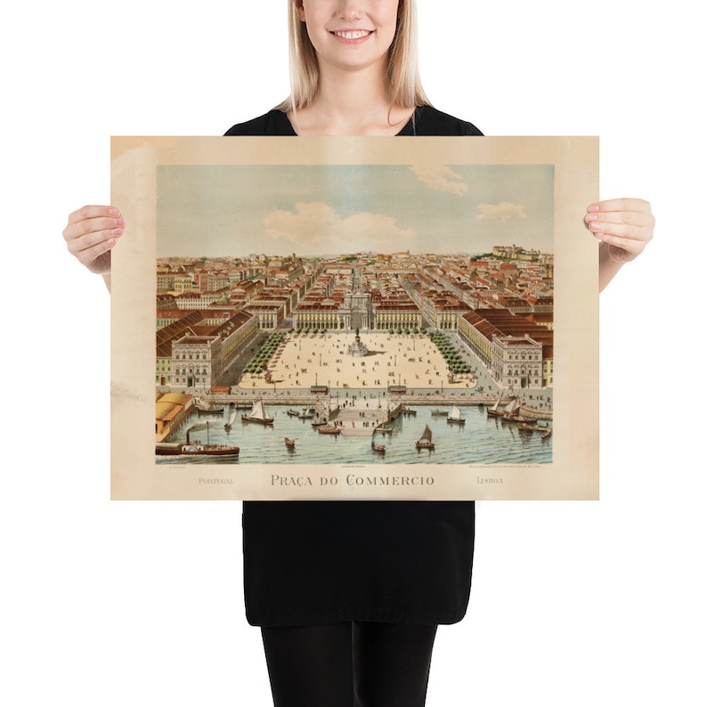 May include: A vintage print of Pra&ccedil;a do Com&eacute;rcio in Lisbon, Portugal, featuring a detailed aerial view of the square, buildings, and harbor with boats. The print has a sepia tone and includes text at the bottom.