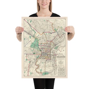 May include: A vintage map of Philadelphia, Pennsylvania, printed in black, red, yellow, green, and blue on a cream-colored background. The map shows the city's streets, parks, and waterways. The title "POLK'S NEW ILLUSTRATED MAP OF PHILADELPHIA" is printed at the bottom of the map.