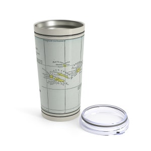 May include: A stainless steel travel mug featuring a vintage map of the Azores islands printed on the side. The map depicts the islands of Graciosa, Pico, Sao Jorge, Terceira, Faial, and Sao Miguel. The mug has a clear lid.