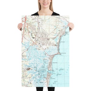 May include: A vintage map of the Hampton, Virginia area, showing the coastline, roads, and waterways. The map is printed on a white background with blue and brown lines.