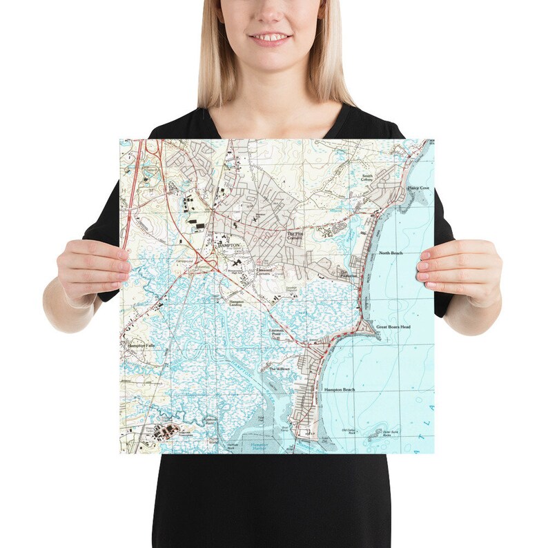 May include: A vintage-style map print of Hampton, Virginia, showing the city's streets, waterways, and coastline. The map is printed in shades of blue, green, and brown, with red lines indicating roads.