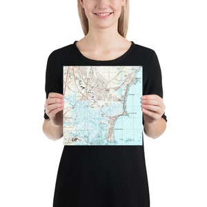 May include: A vintage map of Tybee Island, Georgia, showing the coastline, roads, and landmarks. The map is printed on white paper with blue and brown lines.