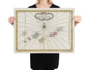 May include: An antique map of the Canary Islands, titled "Carte Des Isles Canaries." The map is printed on aged paper and features a compass rose and detailed lines representing the islands. The islands are colored in shades of pink, green, and yellow.