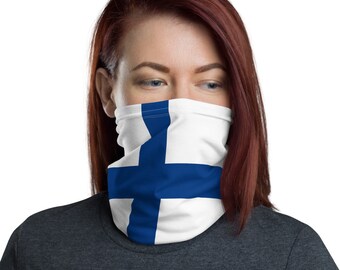 May include: A woman wearing a face covering with the Finnish flag printed on it. The flag is white with a blue cross.