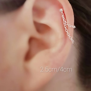 May include: Silver chain earring with a small ball at the top. The chain hangs down from the earlobe. The earring is 2.5cm/4cm long.