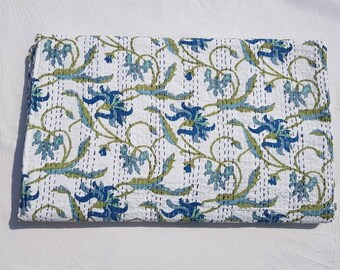 May include: White kantha quilt with a blue and green floral pattern. The quilt is hand-stitched and has a traditional Indian design.